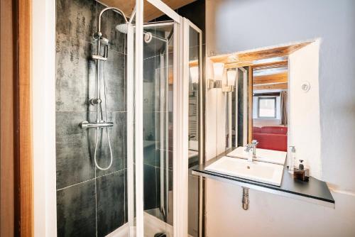a bathroom with a shower and a sink at Ferme Saint-Aubin in Sainte-Foy-Tarentaise