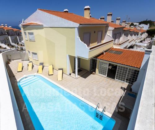 a villa with a swimming pool and a house at Villa BelaVista by ACasaDasCasas in Ericeira