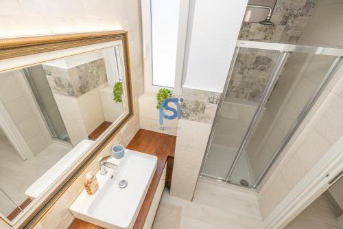 a bathroom with a sink and a shower at Villa Irene Deluxe in Campofelice di Roccella