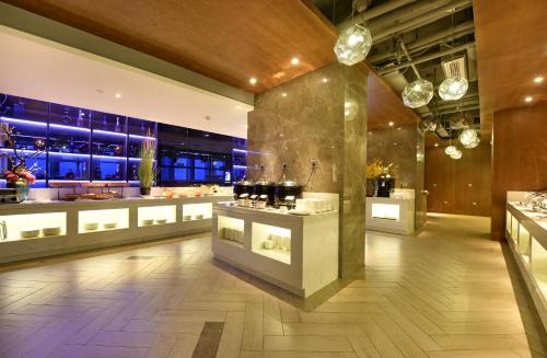a kitchen with a counter with pots and pans at Mehood Lestie Hotel Chengdu Hi-Tech Zone in Chengdu