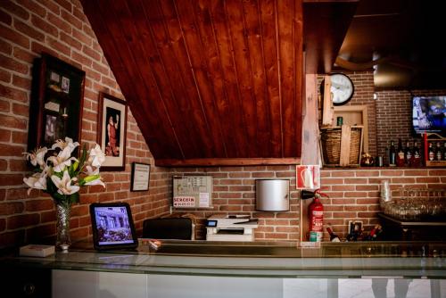 a kitchen with a counter and a brick wall at Hotel Villa De Ermua in Ermua