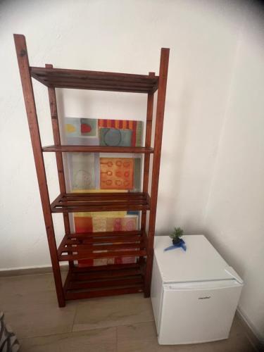a shelf with different items on it next to a box at the lighthouse accommodation in Taranto