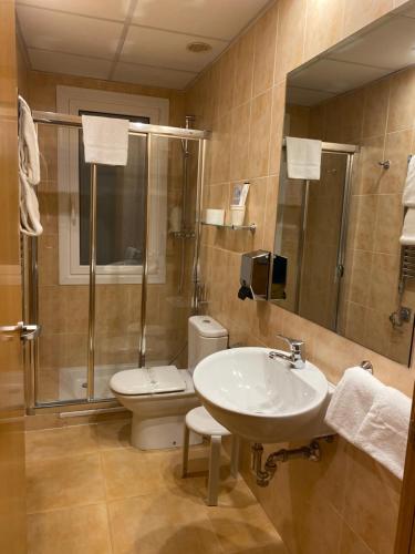 a bathroom with a sink and a toilet and a shower at Hotel Villa De Ermua in Ermua