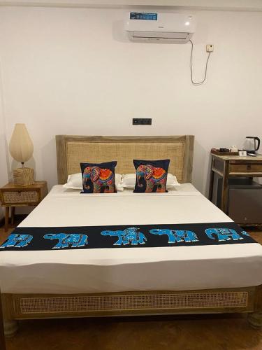 a bed with two pillows on it in a room at Negombo Boutique Villa in Negombo