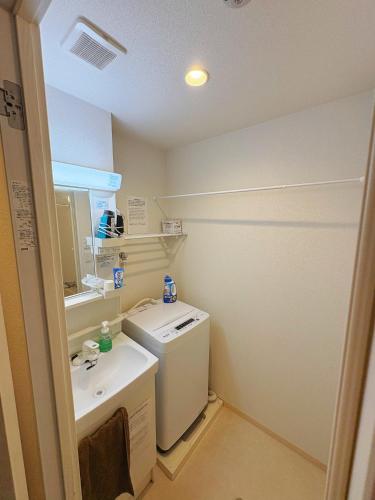 a small bathroom with a sink and a washer at Tokyo Skytree Home Skytree View Hikifune in Tokyo