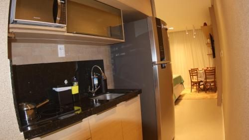 a kitchen with a sink and a refrigerator at ArtStudio Open Spaces in Salvador