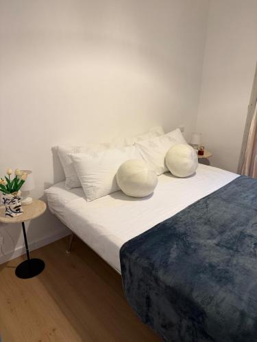 a bedroom with a bed with pillows and a table at Cairoli House- Grottammare in Grottammare