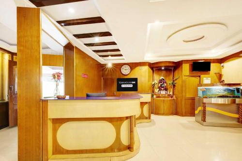 a lobby with a counter and a fish tank at Townhouse Oak Mysore Palace in Mysore