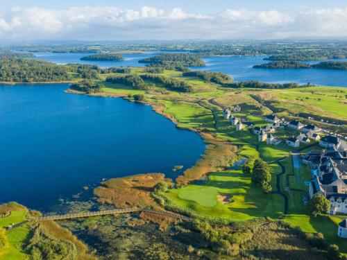 an aerial view of a golf course next to a lake at Lough Erne Resort in Enniskillen