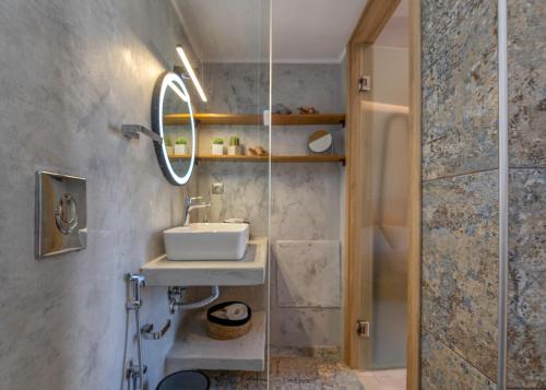 a bathroom with a sink and a mirror at Villa Maritini in Chania Town