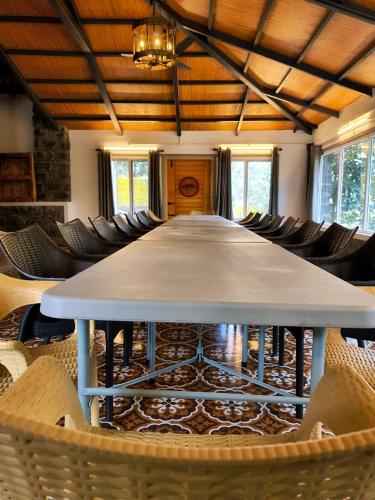 a large table in a room with chairs at Gambhiraa Resorts in Kolli Hills
