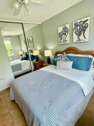 a bedroom with a large bed and a mirror at Casa Encantosyour ideal beachfront destination in Las Coles