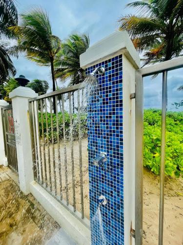 a water fountain on a balcony with a fence at Casa Encantosyour ideal beachfront destination in Las Coles