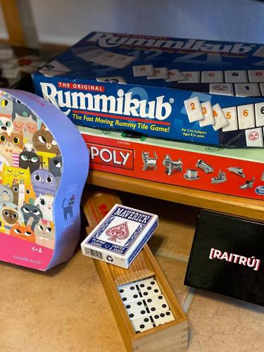 a toy board game and a box of runimulus on a shelf at Casa Encantosyour ideal beachfront destination in Las Coles