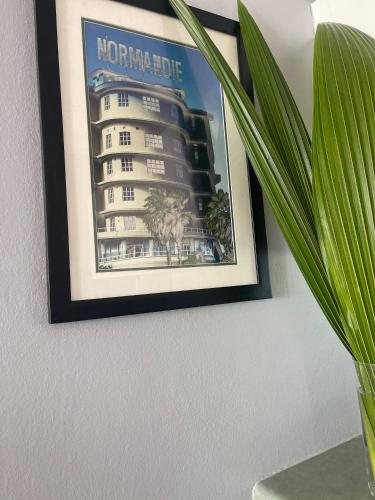 a picture of a hotel hanging on a wall at Casa Encantosyour ideal beachfront destination in Las Coles