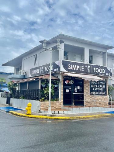a small food store on the corner of a street at Casa Encantosyour ideal beachfront destination in Las Coles