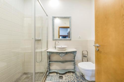 a bathroom with a sink and a toilet at Charming Villa in Quelfes with Shared Pool in Quelfes