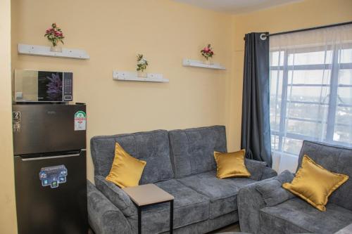 a living room with a couch and a refrigerator at Ordercity in Kisumu