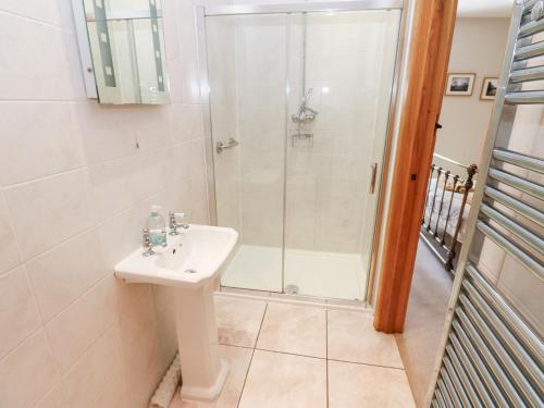 a bathroom with a shower and a sink at Bridge House in Hawes