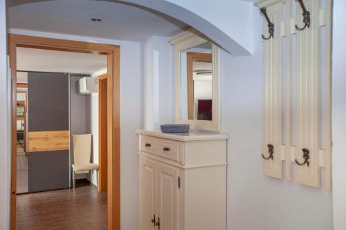 a room with a white cabinet and a mirror at Fewo Schuch in Pirna
