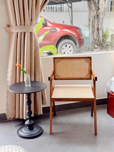 a table and a chair and a table and a car at Malis Homestay in Trà Vinh