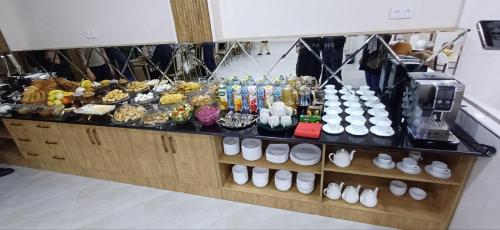 a buffet of food on display in a store at HOSTEL CHINOR in Samarkand