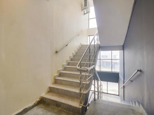 a staircase in a building with a metal railing at Hotel O Abhi's Elite in Warangal