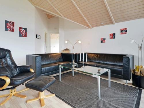 a living room with leather couches and a table at Luxury Spa Retreat by Skaven - By Traum Ferienwohnungen in Hemmet