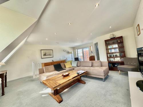 a living room with a couch and a table at Heart of Old Portsmouth in Portsmouth
