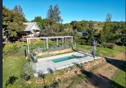 an aerial view of a house with a swimming pool at The Old Church Bed and Breakfast in Boonah