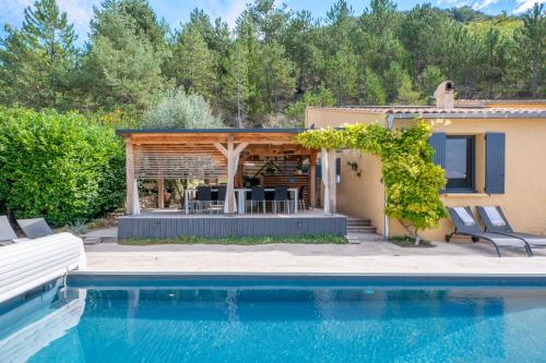 a house with a swimming pool next to a house at Coste in Mollans-sur-Ouvèze