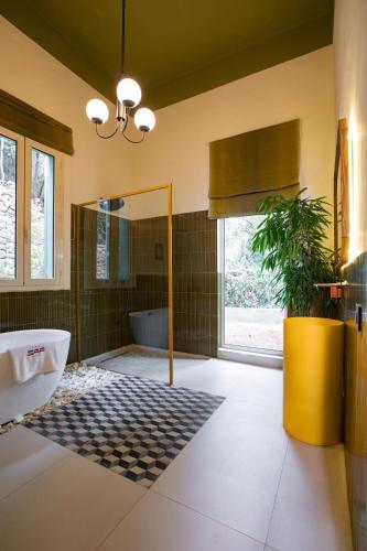 a bathroom with a tub and a sink and a mirror at Villa Saf in Bharsaf