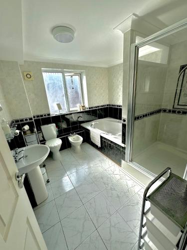 a bathroom with a tub and a toilet and a sink at Heart of Old Portsmouth in Portsmouth