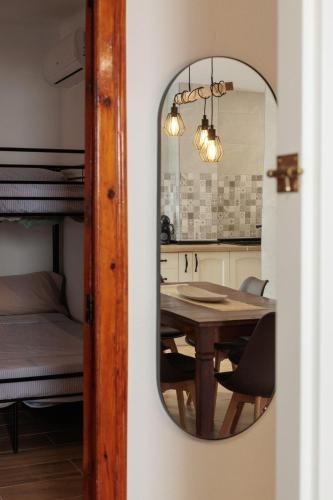 a dining room mirror with a table and a bed at Apartamento Estilo Rustico Buñol - ELPATIO- in Buñol
