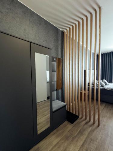 a bedroom with a bed and a mirror at The Bašty Stay in Brno