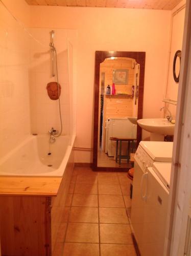 a bathroom with a bath tub and a sink at Mountain Chalet in Beauvezer in Beauvezer