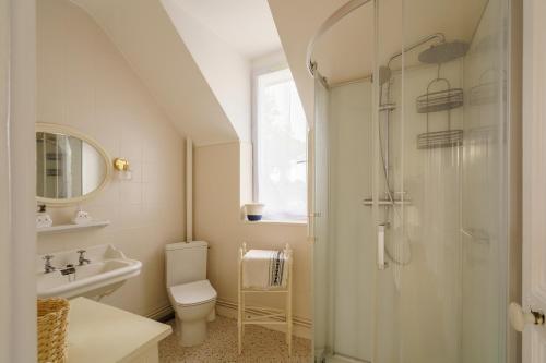 a bathroom with a shower and a toilet and a sink at Ker Gaïdic - Proche Plage in Bénodet