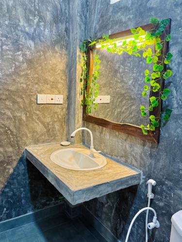 a bathroom with a sink and a mirror at Ramya Ru Nature Resort in Galle