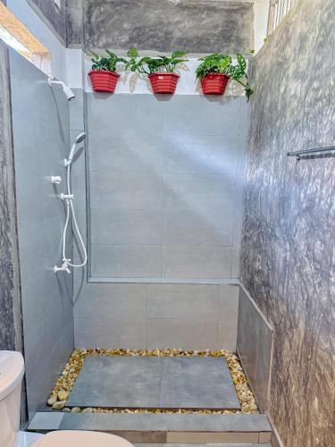 a bathroom with a shower with potted plants at Ramya Ru Nature Resort in Galle