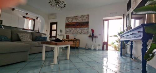 a living room with a couch and a table at Garghe House in Sorrento
