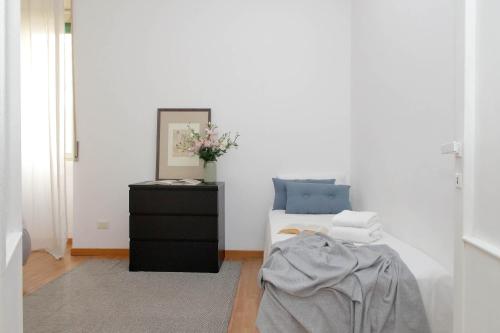 a bedroom with a bed with a black dresser and a mirror at Giuliana Vatican Family Home in Rome