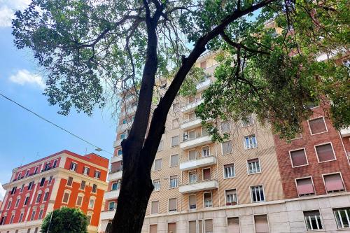 a tree in front of a tall building at Giuliana Vatican Family Home in Rome