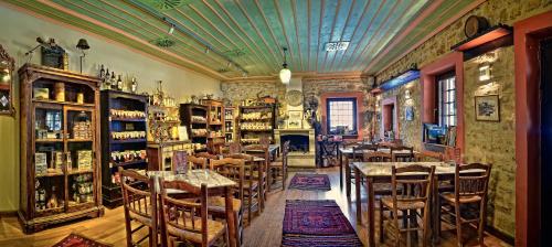 a restaurant with tables and chairs in a room at Frontzu Politia in Ioannina