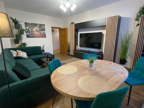 a living room with a table and a couch at Apartament na Placu Swietego Sebastiana in Opole