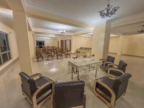 a dining room with a table and chairs at Rare Himalayas De Regency Pelling in Pelling