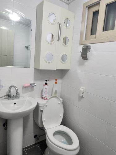 a white bathroom with a toilet and a sink at J 9-minute walk from Nakseongdae Station, quiet neighborhood studio in Samgong