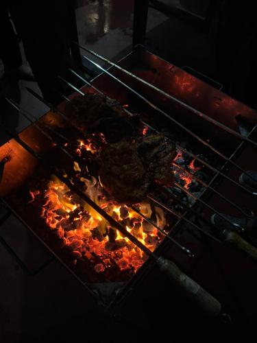 a rack of meat cooking in an oven at Greenspun Nature stay in Somvārpet