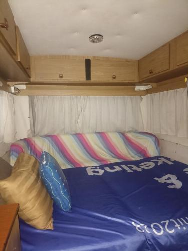 a bed in the back of a trailer at Caravan Hotel have TV & Netflix in Bangkok