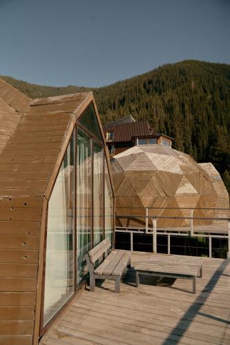 a wooden deck with a bench on top of a building at Pana Unique Kolsay in Kurmenty