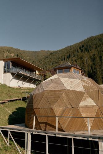 a large wooden building on top of a building at Pana Unique Kolsay in Kurmenty